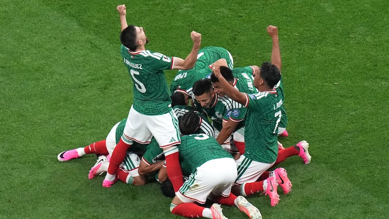 Mexico's Raul Jimenez (9) celebrates with teammates after scoring their second goal during the...