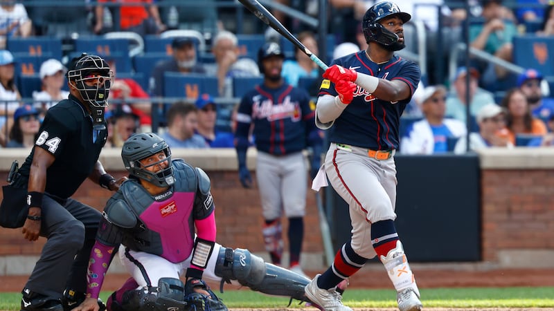 Atlanta Braves' Michael Harris II follows through on a home run during the eighth inning of a...