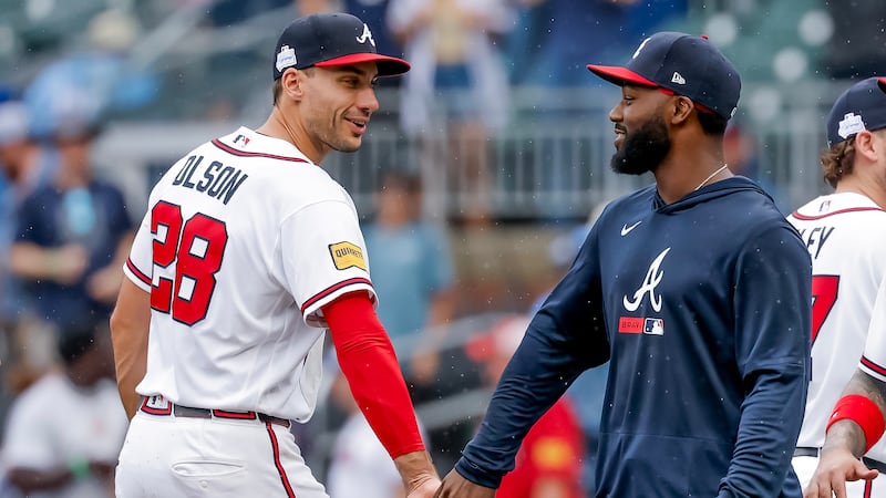 Atlanta Braves' Matt Olson, left, celebrates with Michael Harris II, right, after their team...