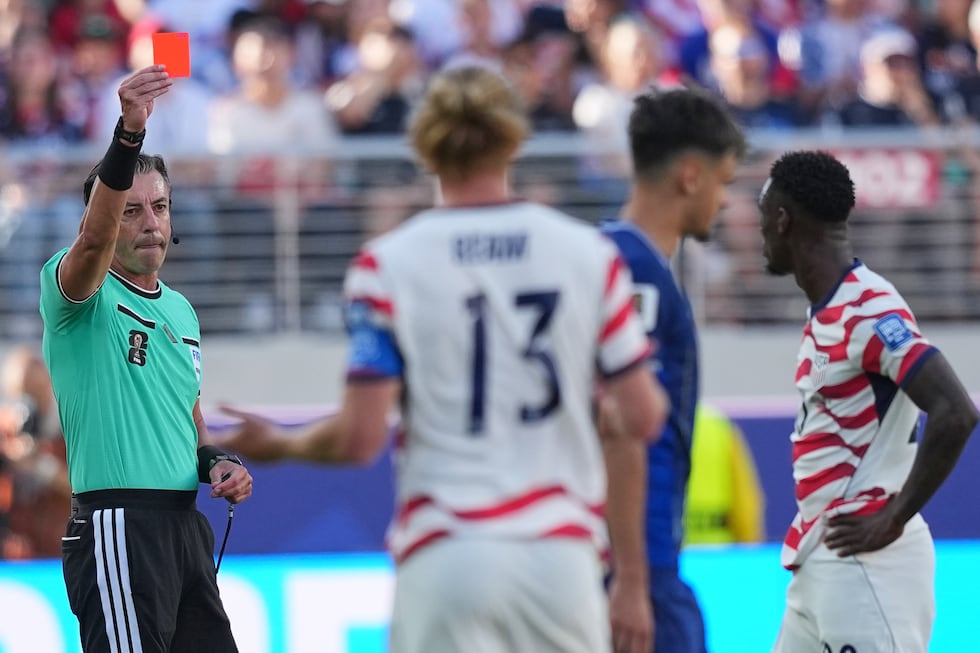Referee Raphael Claus of Brazil shows a red card to United States' Folarin Balogun, right,...