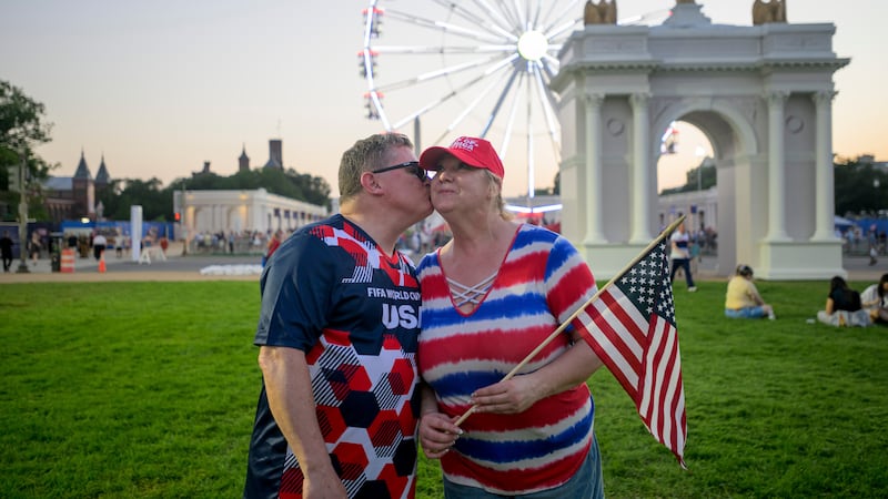 Todd Shaw, left, kisses his wife Shannon Shaw, right, as they pose for portrait during the...