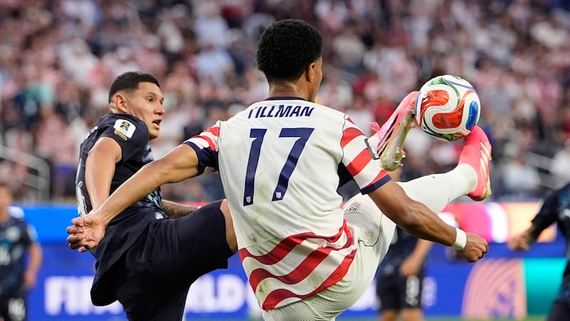 United States' Malik Tillman, right, and Paraguay's Juan Jose Caceres battle for the ball...