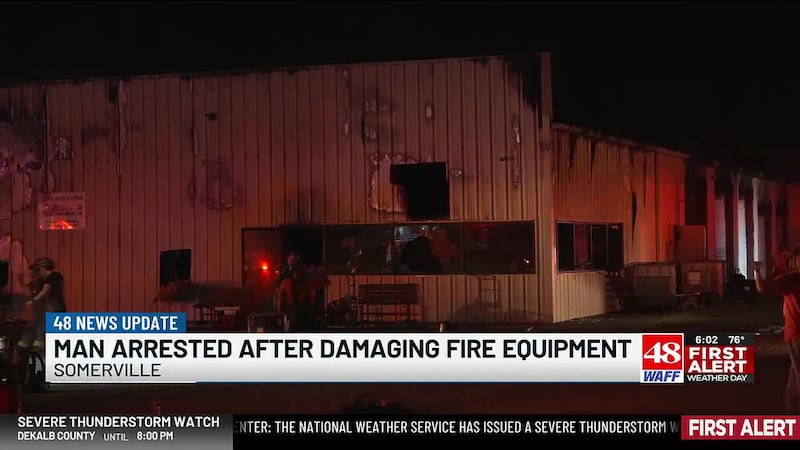 A Morgan County man is behind bars after deputies say he drove through an active fire scene...